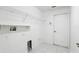 Bright laundry room features white walls, a utility sink, and storage shelves at 1372 Madison Ivy Cir, Apopka, FL 32712