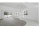 Bright living space with sliding glass doors to the patio, tile and carpet flooring, and a bar counter at 1372 Madison Ivy Cir, Apopka, FL 32712