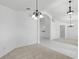 Open living area with seamless flow, tile and carpet flooring, and modern chandeliers at 1372 Madison Ivy Cir, Apopka, FL 32712