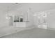 Open-concept living space boasts tile flooring and seamlessly connects to the modern kitchen area at 1372 Madison Ivy Cir, Apopka, FL 32712