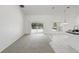Spacious living room with sliding glass doors to the patio, tile and carpet flooring, and a bar counter at 1372 Madison Ivy Cir, Apopka, FL 32712
