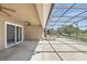 View of covered and enclosed patio with a hot tub, with a view of green backyard at 1372 Madison Ivy Cir, Apopka, FL 32712