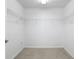 A large carpeted walk-in closet features white walls and wire shelving at 1372 Madison Ivy Cir, Apopka, FL 32712