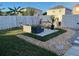 Landscaped backyard oasis featuring a cozy seating area with a porch swing and well-maintained lawn at 14417 Jasmine Glen Dr, Orlando, FL 32824