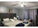 Comfortable bedroom with a ceiling fan, warm lighting, and stylish decor, creating a relaxed atmosphere at 14417 Jasmine Glen Dr, Orlando, FL 32824