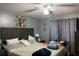 Bedroom with an accent wall, a ceiling fan, and a wooden bed frame at 14417 Jasmine Glen Dr, Orlando, FL 32824