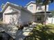 Exterior view of home showcasing garage, walkway, and manicured front lawn at 14417 Jasmine Glen Dr, Orlando, FL 32824
