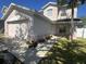 Charming two-story house featuring a two car garage and manicured landscaping at 14417 Jasmine Glen Dr, Orlando, FL 32824