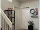 Interior hallway with white doors and a staircase, featuring decorative shelving and a potted plant at 14417 Jasmine Glen Dr, Orlando, FL 32824