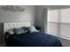 Serene bedroom featuring a plush bed, soft lighting, and a large window at 14417 Jasmine Glen Dr, Orlando, FL 32824