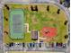 An aerial view of a community park featuring tennis courts, playground, and parking lot at 754 Andalusia Loop, Davenport, FL 33837