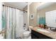 Full bathroom featuring a shower-tub combo with a white shower curtain and vanity with granite countertop at 754 Andalusia Loop, Davenport, FL 33837
