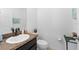 Half bathroom featuring granite countertop, white ceramic sink, and neutral wall paint at 754 Andalusia Loop, Davenport, FL 33837