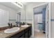 Bathroom featuring double sinks and a granite countertop, with a view into a tub-shower combo at 754 Andalusia Loop, Davenport, FL 33837