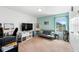 Versatile bedroom with a TV, futon, shelves, and a window with a street view, perfect for study or lounging at 754 Andalusia Loop, Davenport, FL 33837