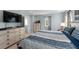 Comfortable bedroom showcasing a king-size bed, large dresser and window to exterior at 754 Andalusia Loop, Davenport, FL 33837