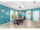 Bright dining room with a modern light fixture, tile floors, and views of the landscaped front yard at 754 Andalusia Loop, Davenport, FL 33837