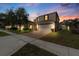 Charming two-story home with a brick paver driveway, manicured lawn, and attached two-car garage at 754 Andalusia Loop, Davenport, FL 33837