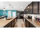Open kitchen with granite countertops, stainless steel appliances, and ample counter space for cooking and entertaining at 754 Andalusia Loop, Davenport, FL 33837