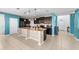 Spacious kitchen with granite countertops, dark cabinetry, stainless steel appliances, and tiled flooring at 754 Andalusia Loop, Davenport, FL 33837