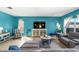 Bright living room featuring blue accent walls, tile flooring, comfortable furniture, and lots of natural light at 754 Andalusia Loop, Davenport, FL 33837