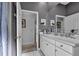 Bathroom featuring a large mirror, white vanity, and tile flooring at 867 Hanover Way, Lakeland, FL 33813