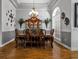 Formal dining room featuring a beautiful chandelier, hardwood floors, and decorative wall art at 867 Hanover Way, Lakeland, FL 33813