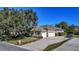 Spacious home with a three-car garage, a long driveway, and well-manicured lawn and landscaping at 867 Hanover Way, Lakeland, FL 33813