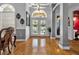 Grand foyer with hardwood floors, decorative columns, arched doorways, and an abundance of natural light at 867 Hanover Way, Lakeland, FL 33813