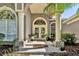 Inviting front entrance with beautiful double doors, decorative plants, and ample natural light at 867 Hanover Way, Lakeland, FL 33813