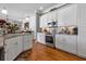 Bright kitchen featuring white cabinetry, stainless steel appliances, and a hardwood floor at 867 Hanover Way, Lakeland, FL 33813