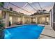 Beautiful backyard pool with covered patio area and string lights at 867 Hanover Way, Lakeland, FL 33813