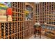 Custom wine cellar showcasing extensive wine racks, a tasting area, and decorative accents at 867 Hanover Way, Lakeland, FL 33813