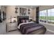 Cozy bedroom features a stylish bed, unique nightstands, and a large window with scenic views at 2144 Babbling Brook Blvd, Auburndale, FL 33823