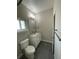 Well-lit bathroom featuring a sleek vanity with a decorative framed mirror and modern fixtures at 261 E 5Th St, Chuluota, FL 32766