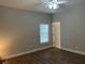 Spacious bedroom with wood floors, a ceiling fan, and a window at 261 E 5Th St, Chuluota, FL 32766