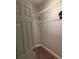 Walk-in closet with ample shelving and laminate wood flooring at 261 E 5Th St, Chuluota, FL 32766