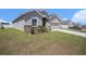 Charming single-story home with gray stucco, stone accents, and a well-manicured lawn at 7066 Victoria Rd, Lakeland, FL 33809