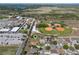Drone shot of a single-Gathering home near a school, baseball fields, tennis courts, and farmland at 1112 View Pointe Cir, Lake Wales, FL 33853