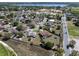 Wide aerial shot showing a nice home with a pool, a good-sized lot, and mature landscaping at 1112 View Pointe Cir, Lake Wales, FL 33853