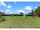 Expansive backyard featuring a trampoline, playground equipment, and lush green grass at 1112 View Pointe Cir, Lake Wales, FL 33853