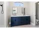 Modern bathroom features a double sink vanity with a blue base and a walk-in shower, all well lit at 1112 View Pointe Cir, Lake Wales, FL 33853