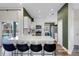 Modern kitchen boasts white cabinets, stainless appliances, and breakfast bar with views of the pool at 1112 View Pointe Cir, Lake Wales, FL 33853