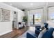 This bright living area features hardwood floors, comfortable blue seating and sliding glass doors to the backyard at 1112 View Pointe Cir, Lake Wales, FL 33853