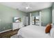 Lovely main bedroom with calming green walls, ceiling fan, and sliding glass doors to the outdoor pool area at 1112 View Pointe Cir, Lake Wales, FL 33853
