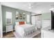 Comfortable primary bedroom with green walls, a ceiling fan, and a barn door leading to the ensuite bathroom at 1112 View Pointe Cir, Lake Wales, FL 33853