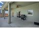 Spacious outdoor patio featuring an outdoor grill, ceiling fans, and access to the home's interior at 1112 View Pointe Cir, Lake Wales, FL 33853