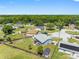 Aerial view showcasing a well-maintained lawn with fencing, detached shed, and a gray-roofed home at 3548 Galloway Oaks Ct, Lakeland, FL 33810