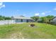Backyard with a green lawn, a screened-in porch, and a fire pit feature at 3548 Galloway Oaks Ct, Lakeland, FL 33810