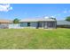 Spacious backyard with a screened lanai, featuring a well-maintained lawn, partial fence and abundant natural light at 3548 Galloway Oaks Ct, Lakeland, FL 33810